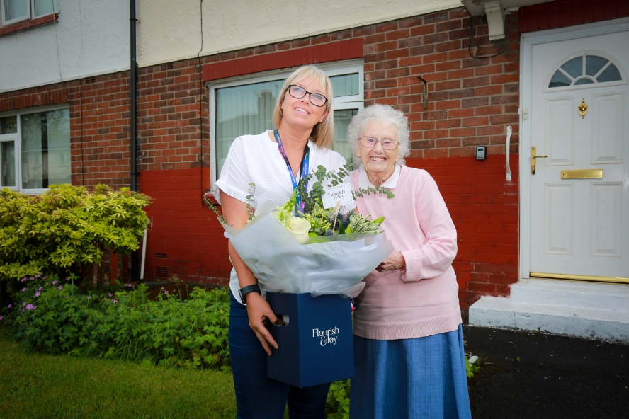 7. Salix Homes housing officer Yvette Traynor gives flowers to Mary Jones.jpg