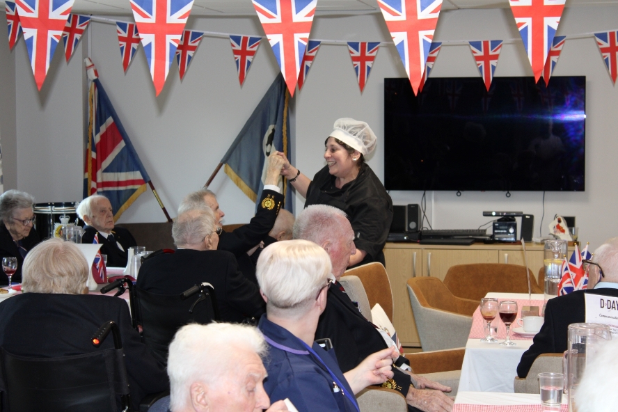 D-Day party at Broughton House Veteran Care Village 2024 - kitchen assistant Debbie Tyldesley joins in the fun with residents.JPG